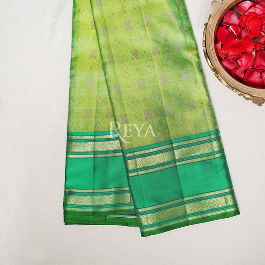 'Emerald Enchantress Kanjeevaram' in parrot green and temple gold